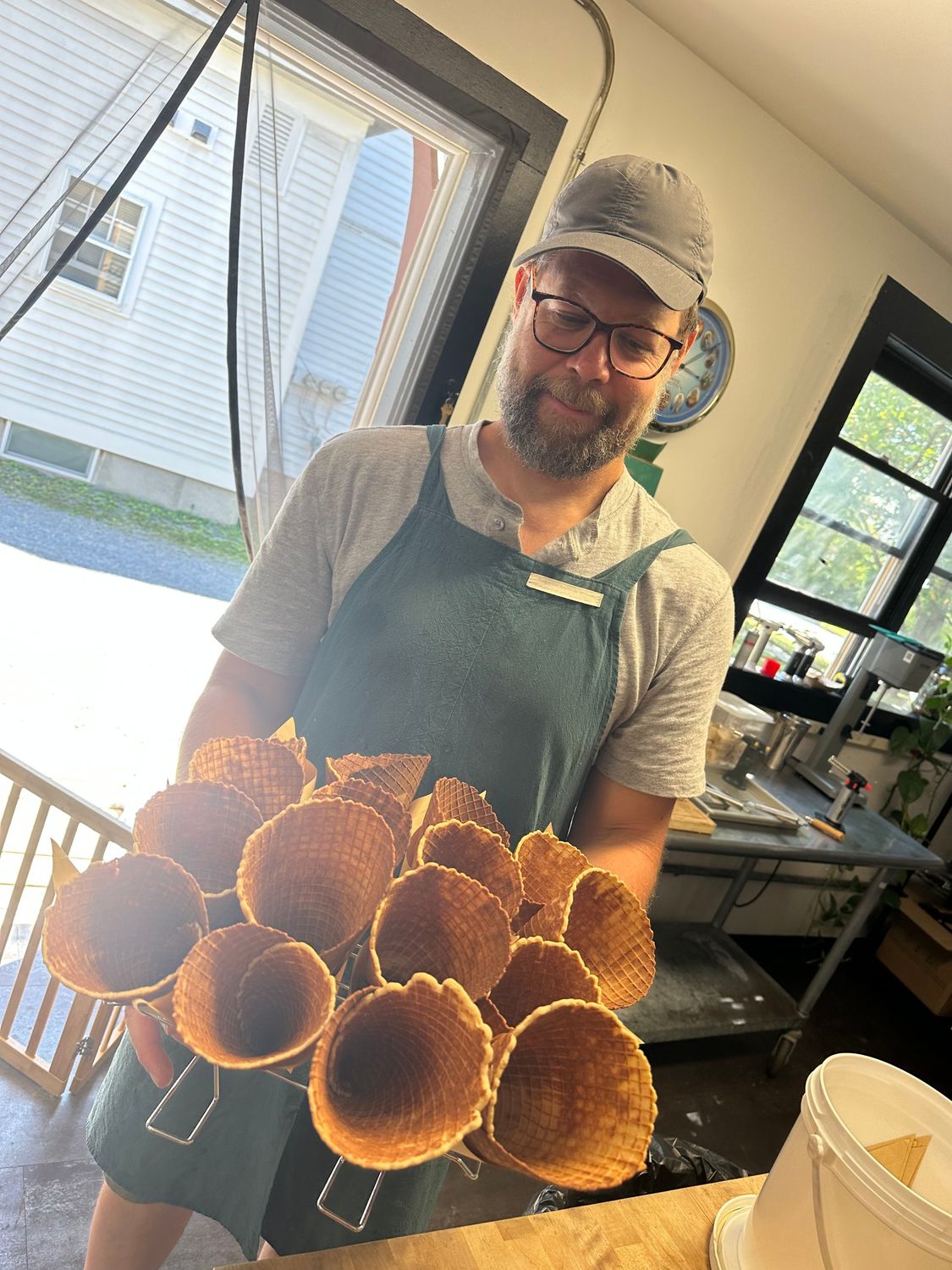 Shaun holding a rack of waffle cones